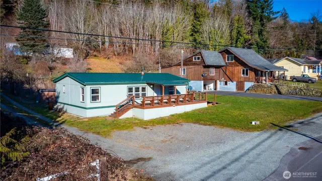 a view of a house with a yard and sitting area