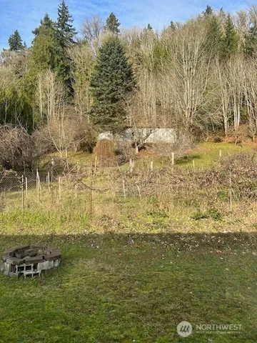 a view of a house with a chairs and table in a patio