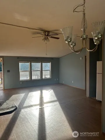 a dining room with furniture wooden floor a rug and a chandelier