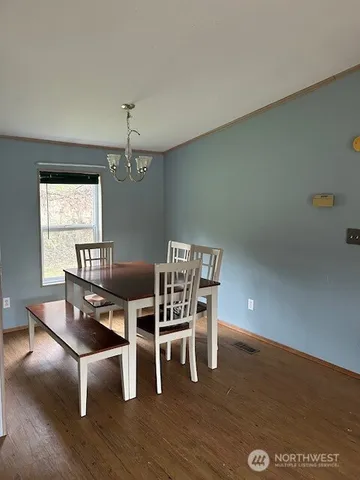 an empty room with wooden floor and a window