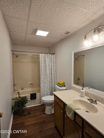 a bathroom with a sink mirror and toilet