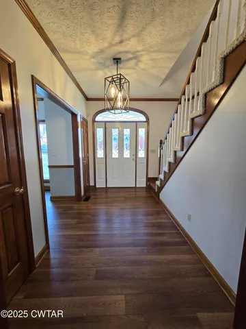 a view of entryway and hall with wooden floor
