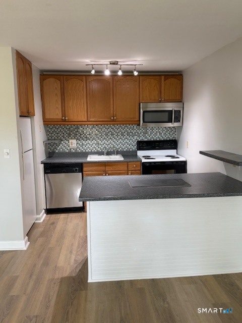 a kitchen with stainless steel appliances kitchen island a cabinets and wooden floor