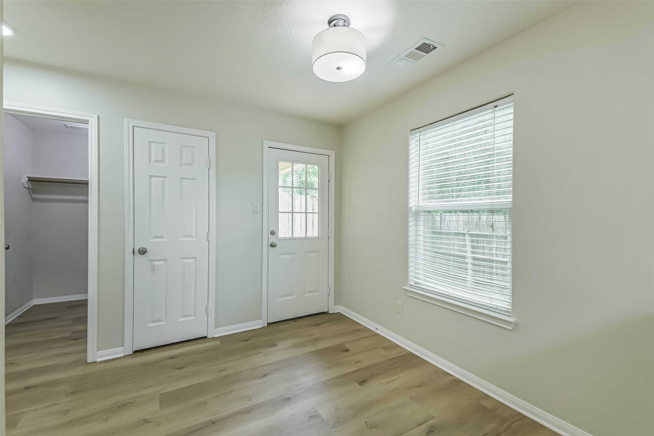 1799 League Line Road, Unit 1 Conroe, TX 77304 - Photo 13 of 32 The dining room with sleek light fixture, access to the backyard, pantry, and utility room.