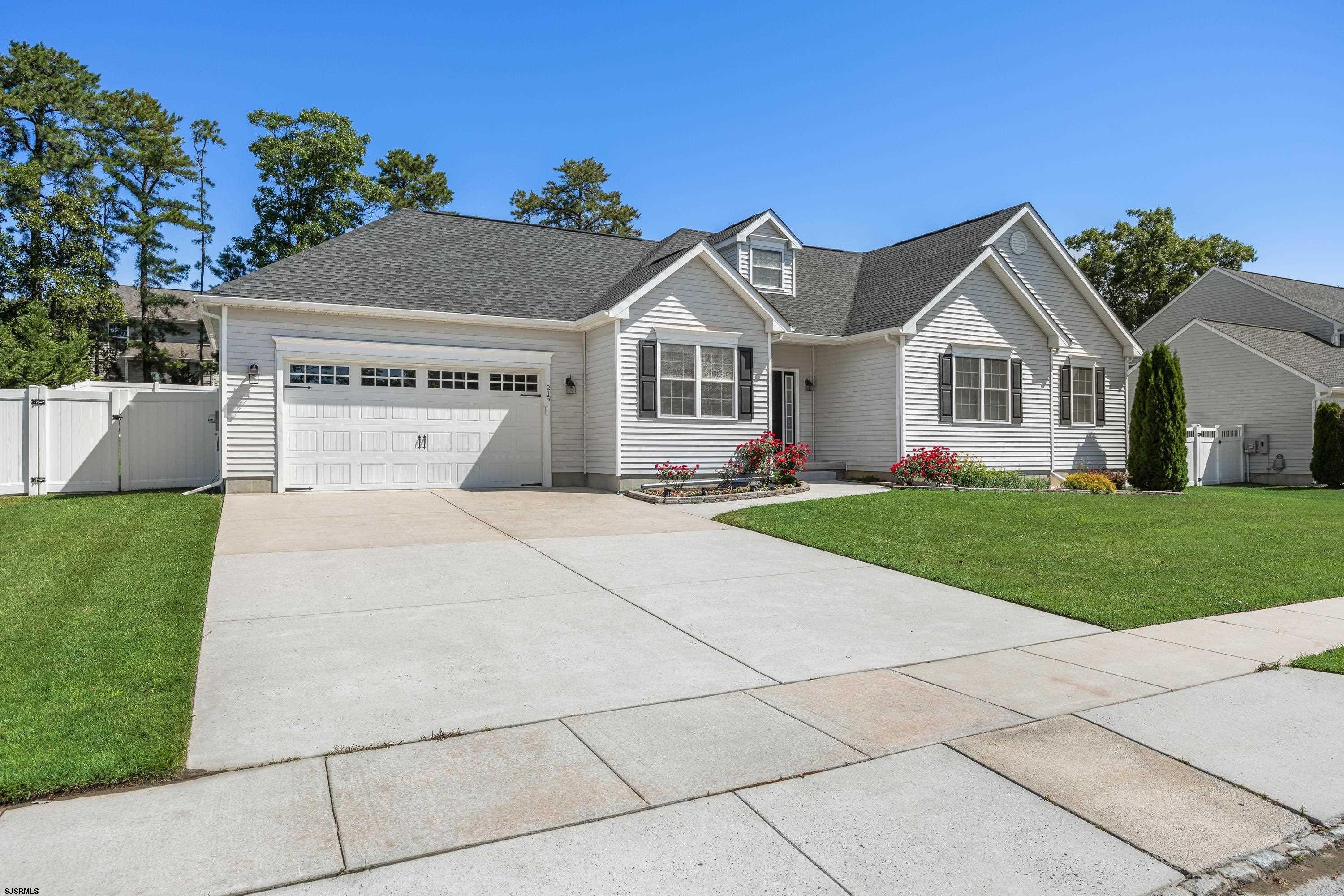 215 Surf Road Egg Harbor Township, NJ 08234 - Photo 2 of 31 a front view of a house with a garden and yard
