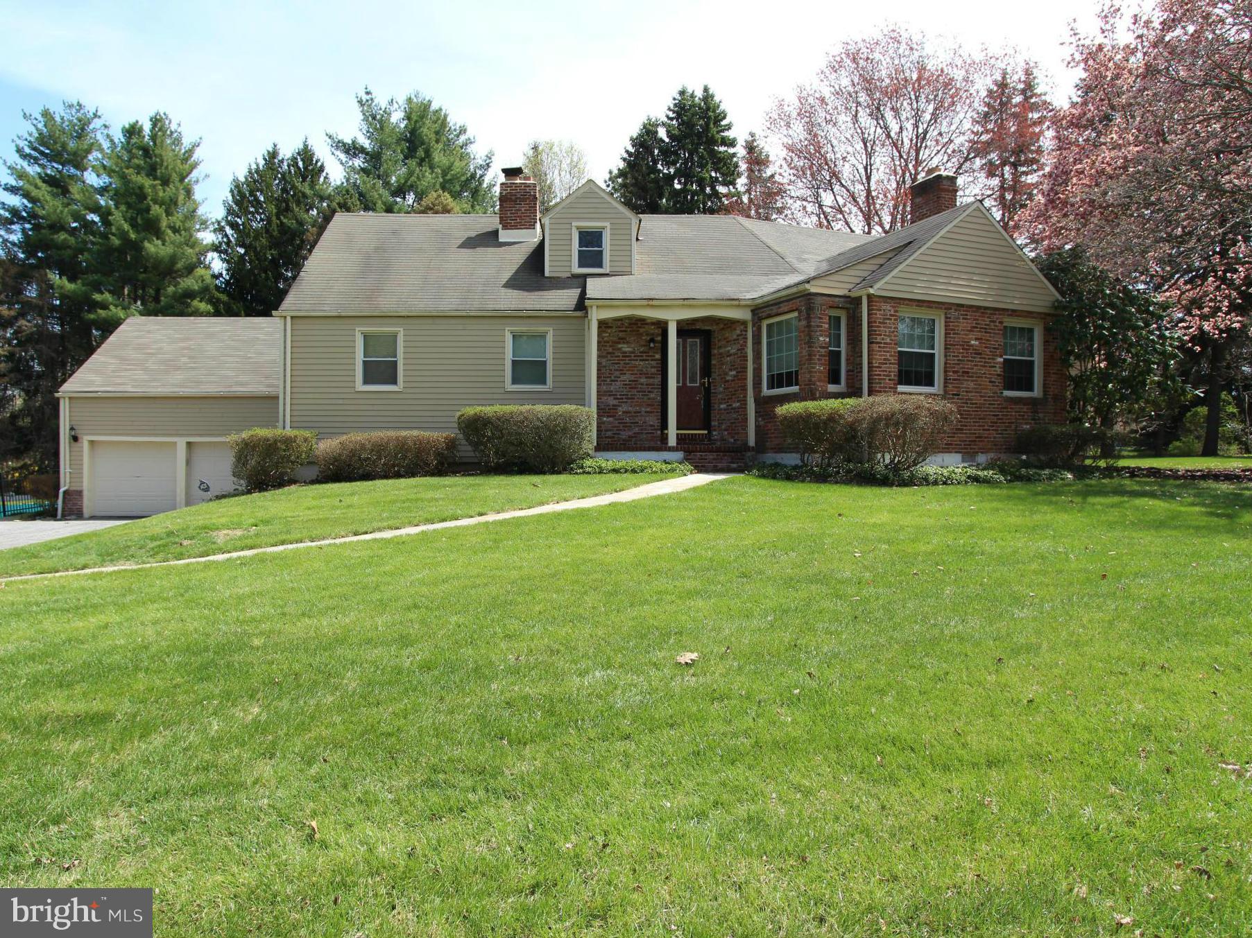 8720 Windsor Mill Road Baltimore, MD 21244 - Photo 1 of 27 a front view of a house with a yard and garage