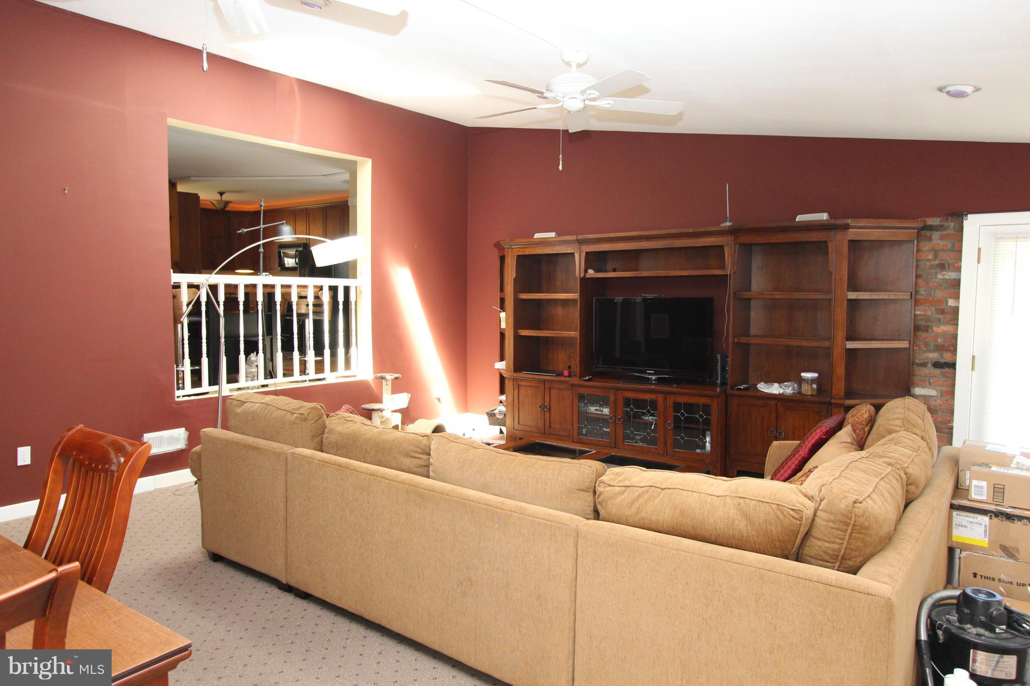 8720 Windsor Mill Road Baltimore, MD 21244 - Photo 14 of 27 a living room with furniture and a flat screen tv