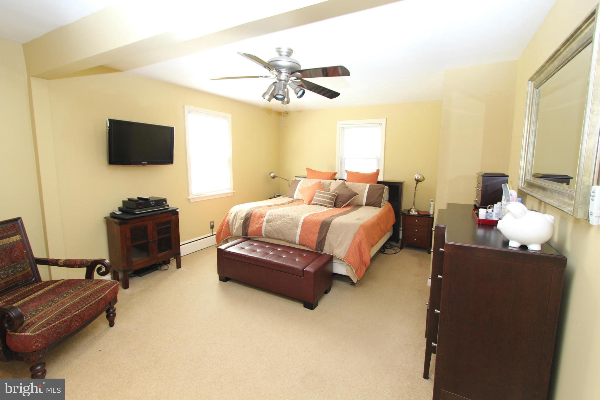 8720 Windsor Mill Road Baltimore, MD 21244 - Photo 16 of 27 a bedroom with a bed and a television
