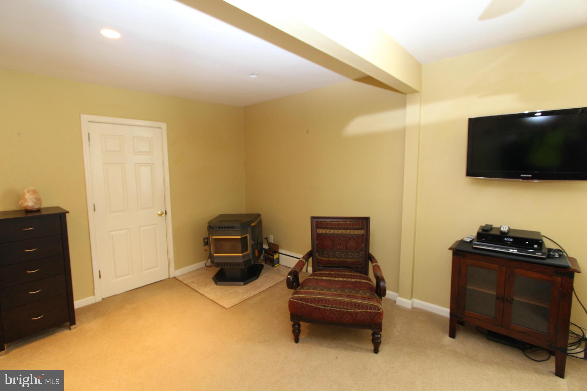 8720 Windsor Mill Road Baltimore, MD 21244 - Photo 17 of 27 a living room with furniture and a flat screen tv