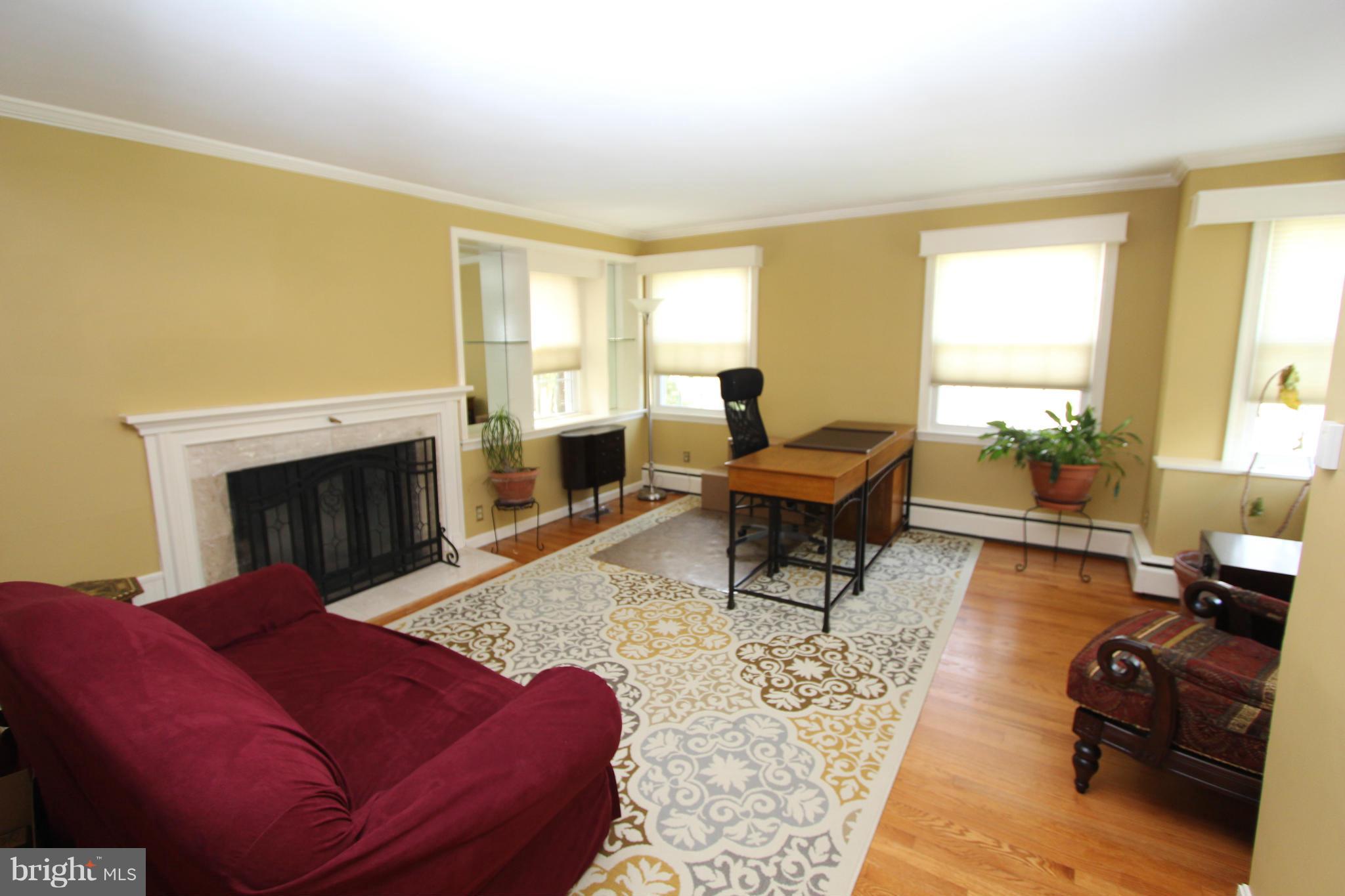 8720 Windsor Mill Road Baltimore, MD 21244 - Photo 21 of 27 a living room with furniture and a fireplace