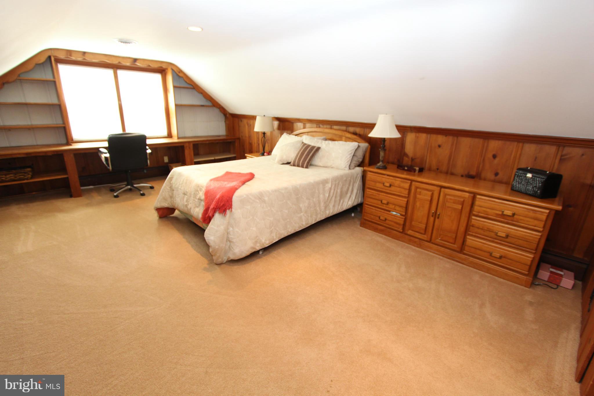 8720 Windsor Mill Road Baltimore, MD 21244 - Photo 22 of 27 a bedroom with a bed next to window with lamp