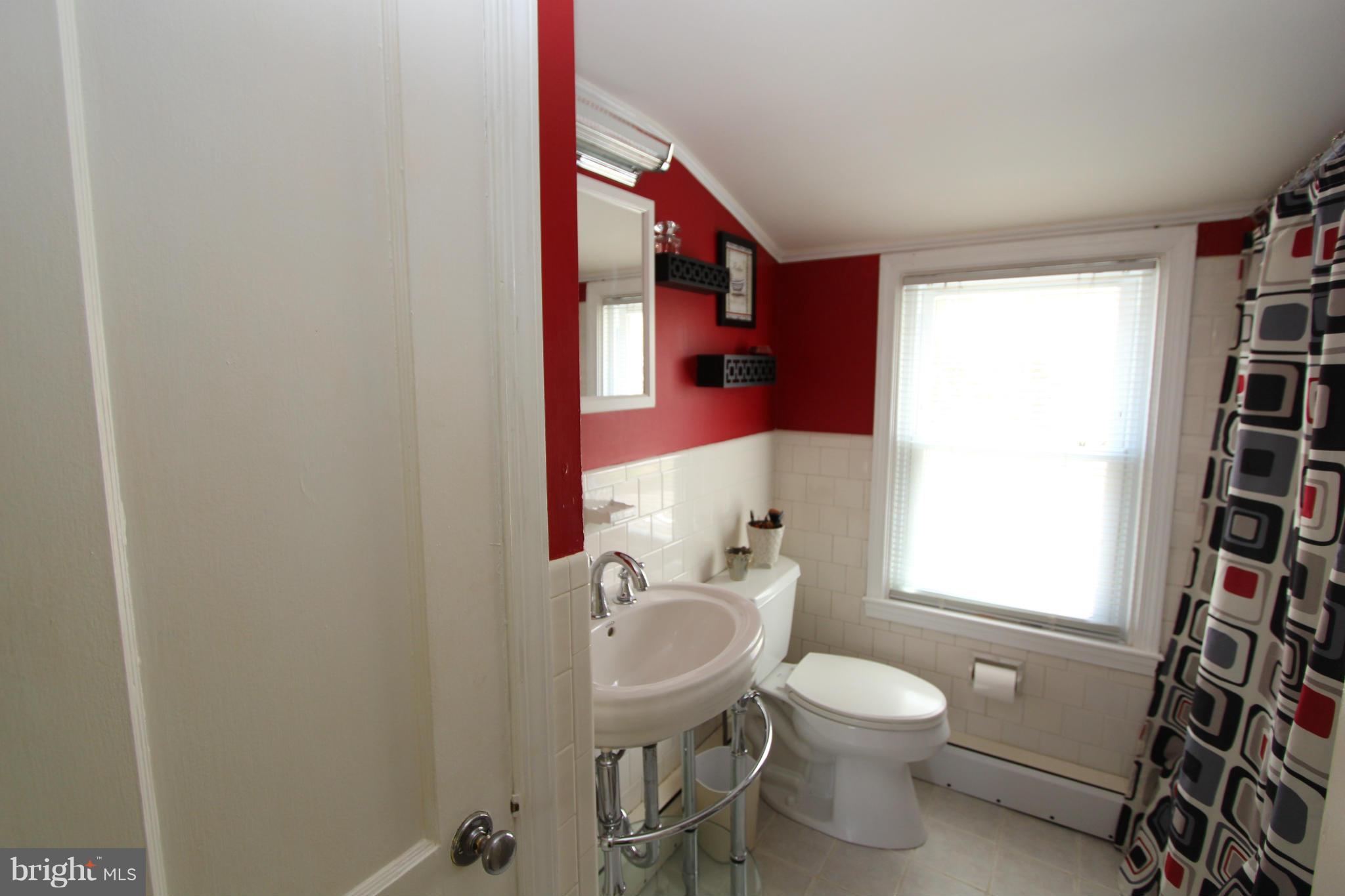 8720 Windsor Mill Road Baltimore, MD 21244 - Photo 24 of 27 a bathroom with a toilet a sink and a mirror
