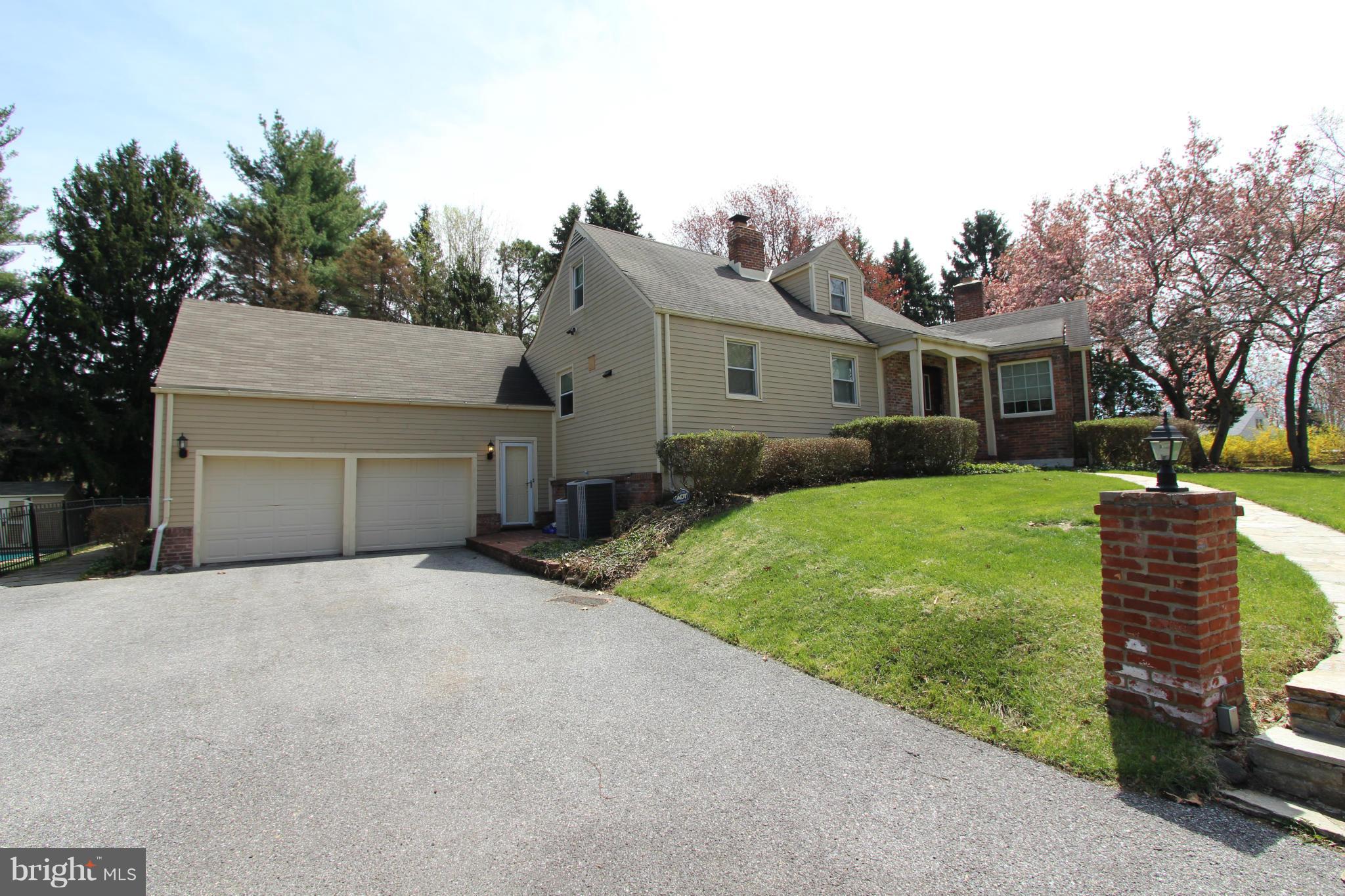 8720 Windsor Mill Road Baltimore, MD 21244 - Photo 27 of 27 a front view of a house with a garden and trees