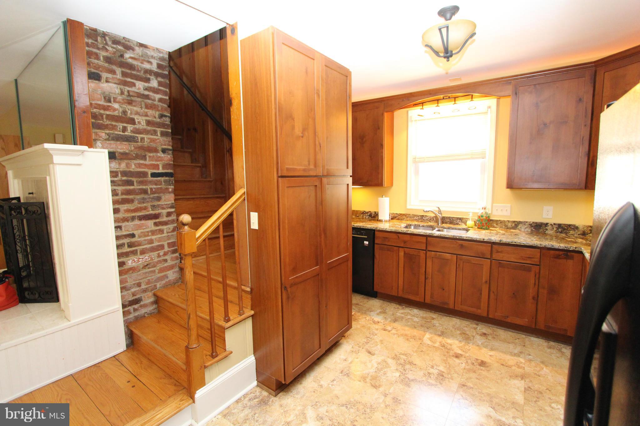 8720 Windsor Mill Road Baltimore, MD 21244 - Photo 7 of 27 a kitchen with stainless steel appliances granite countertop a refrigerator and a stove top oven