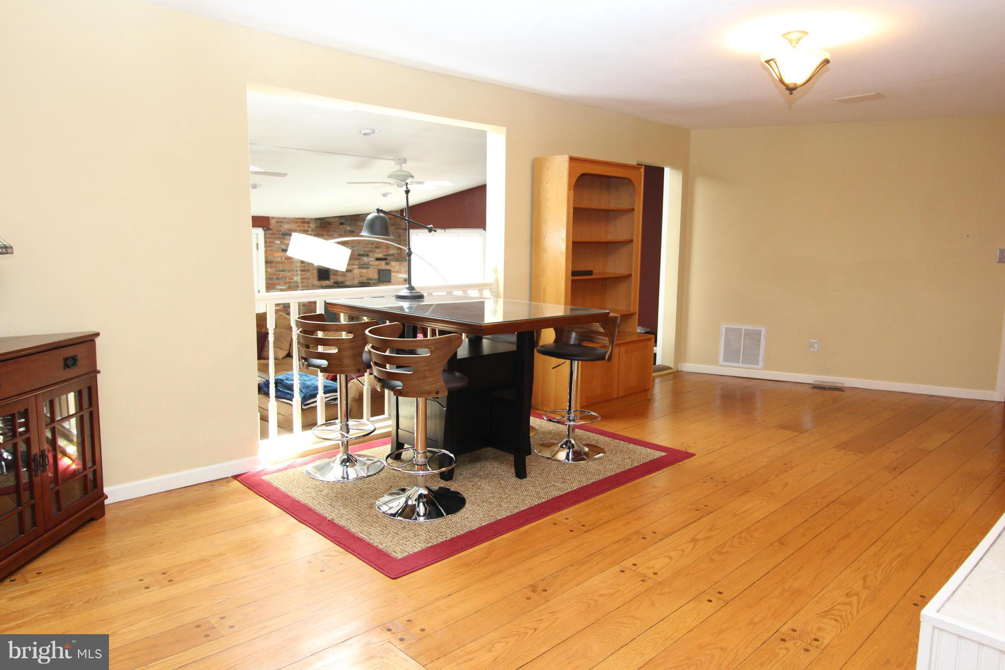 8720 Windsor Mill Road Baltimore, MD 21244 - Photo 9 of 27 a living room with furniture a flat screen tv and a table