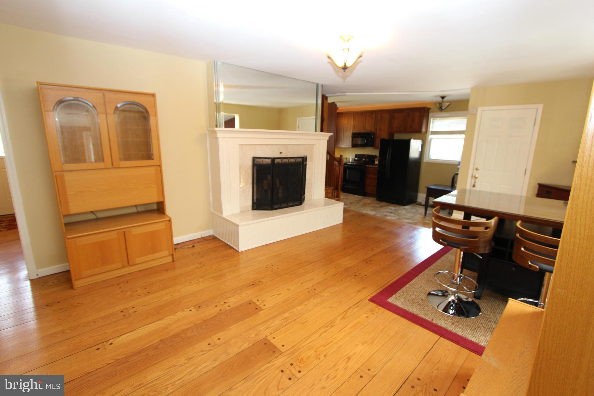 8720 Windsor Mill Road Baltimore, MD 21244 - Photo 10 of 27 a living room with furniture and a fireplace