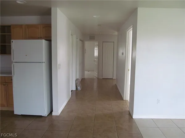 a view of a hallway to rooms