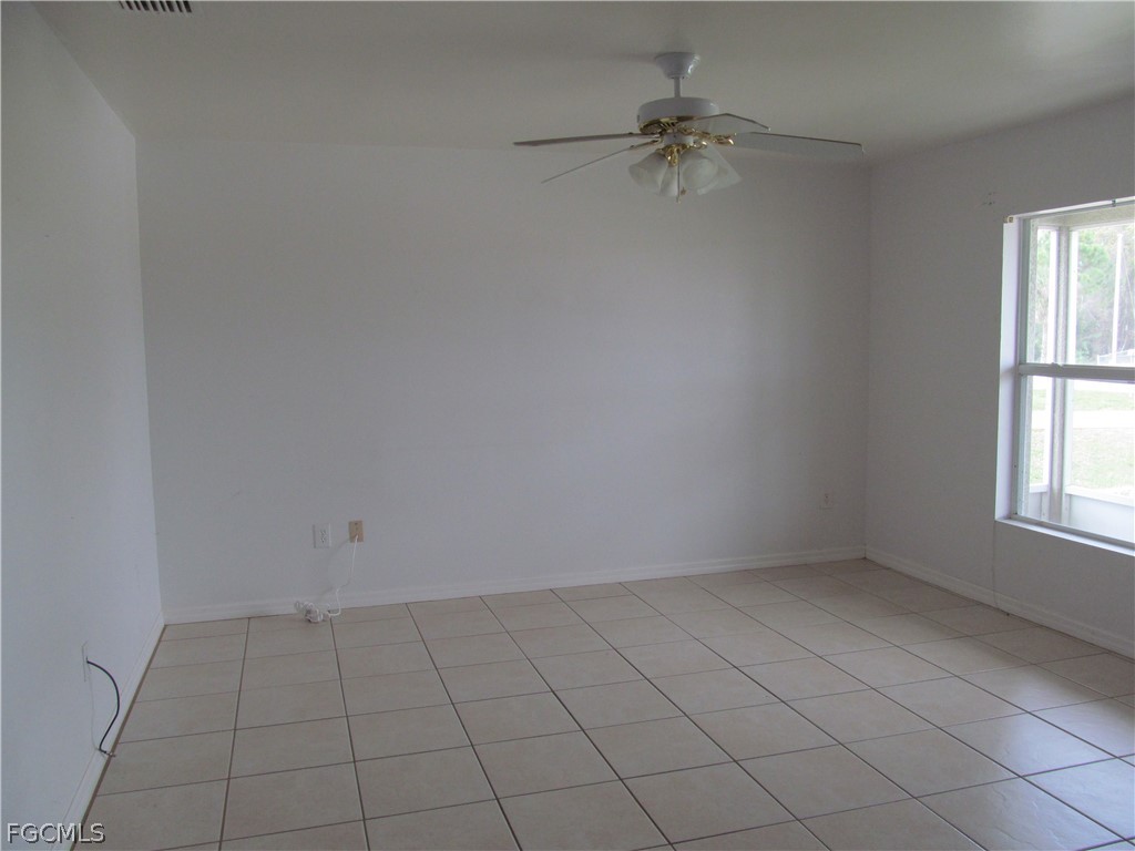 664 Alabama Road South Lehigh Acres, FL 33974 - Photo 4 of 7 an empty room with a window