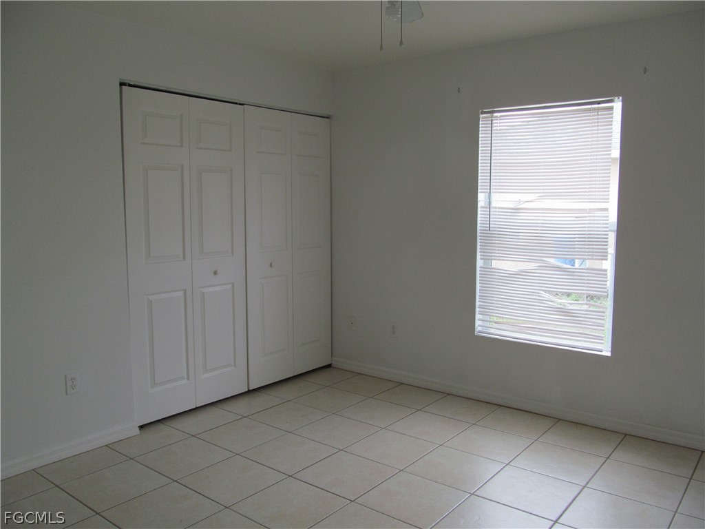 664 Alabama Road South Lehigh Acres, FL 33974 - Photo 5 of 7 a view of an empty room with window and closet area