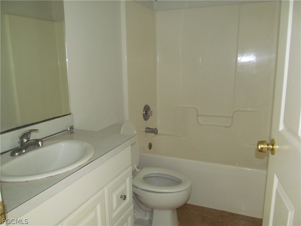 664 Alabama Road South Lehigh Acres, FL 33974 - Photo 6 of 7 a bathroom with a sink a toilet and shower