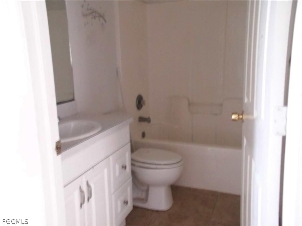 664 Alabama Road South Lehigh Acres, FL 33974 - Photo 7 of 7 a bathroom with a sink a toilet and shower