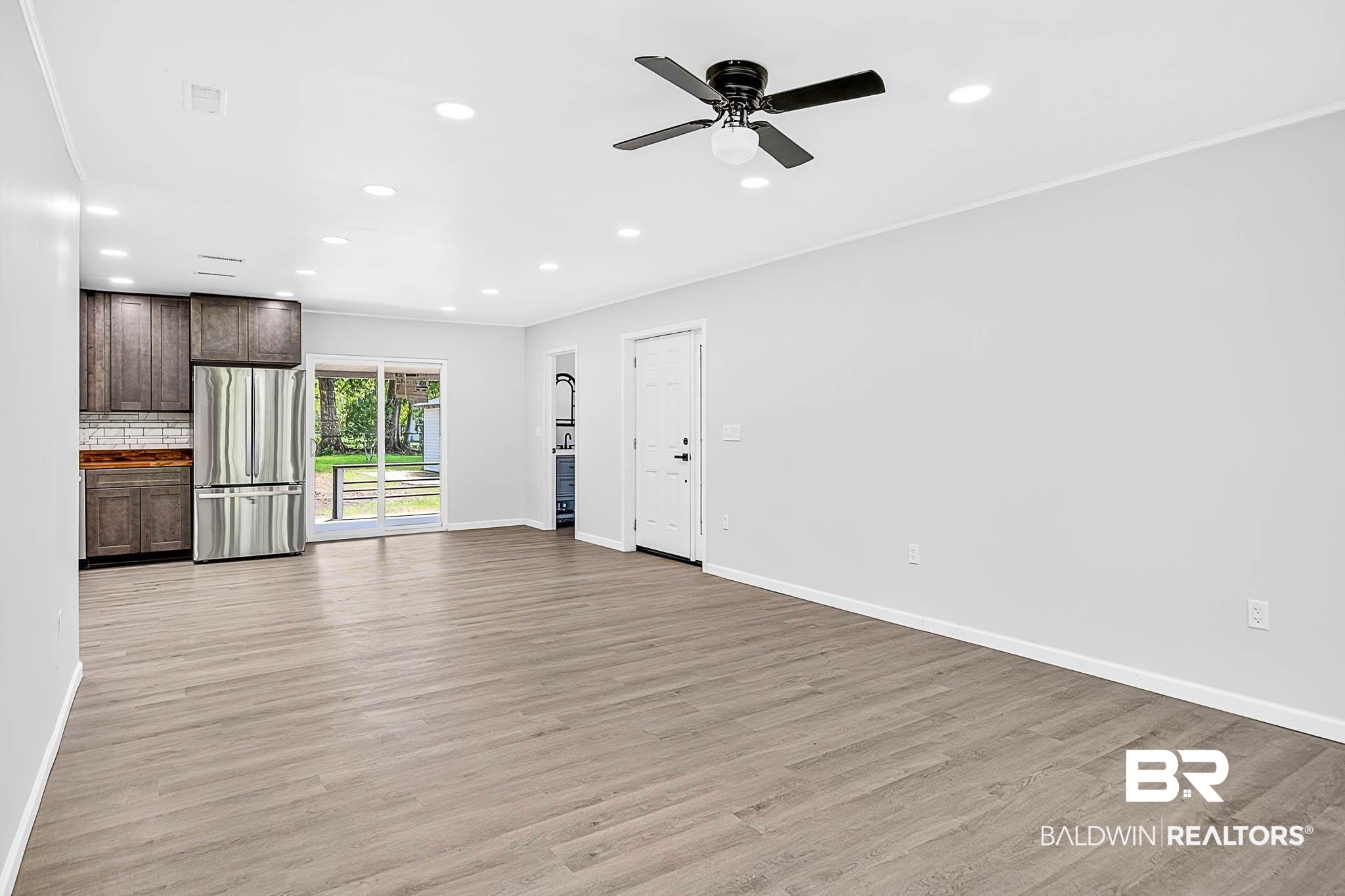 101 Terry Avenue Brewton, AL 36426 - Photo 29 of 48 Unfurnished living room featuring light wood-style floors, recessed lighting, ceiling fan, and crown molding