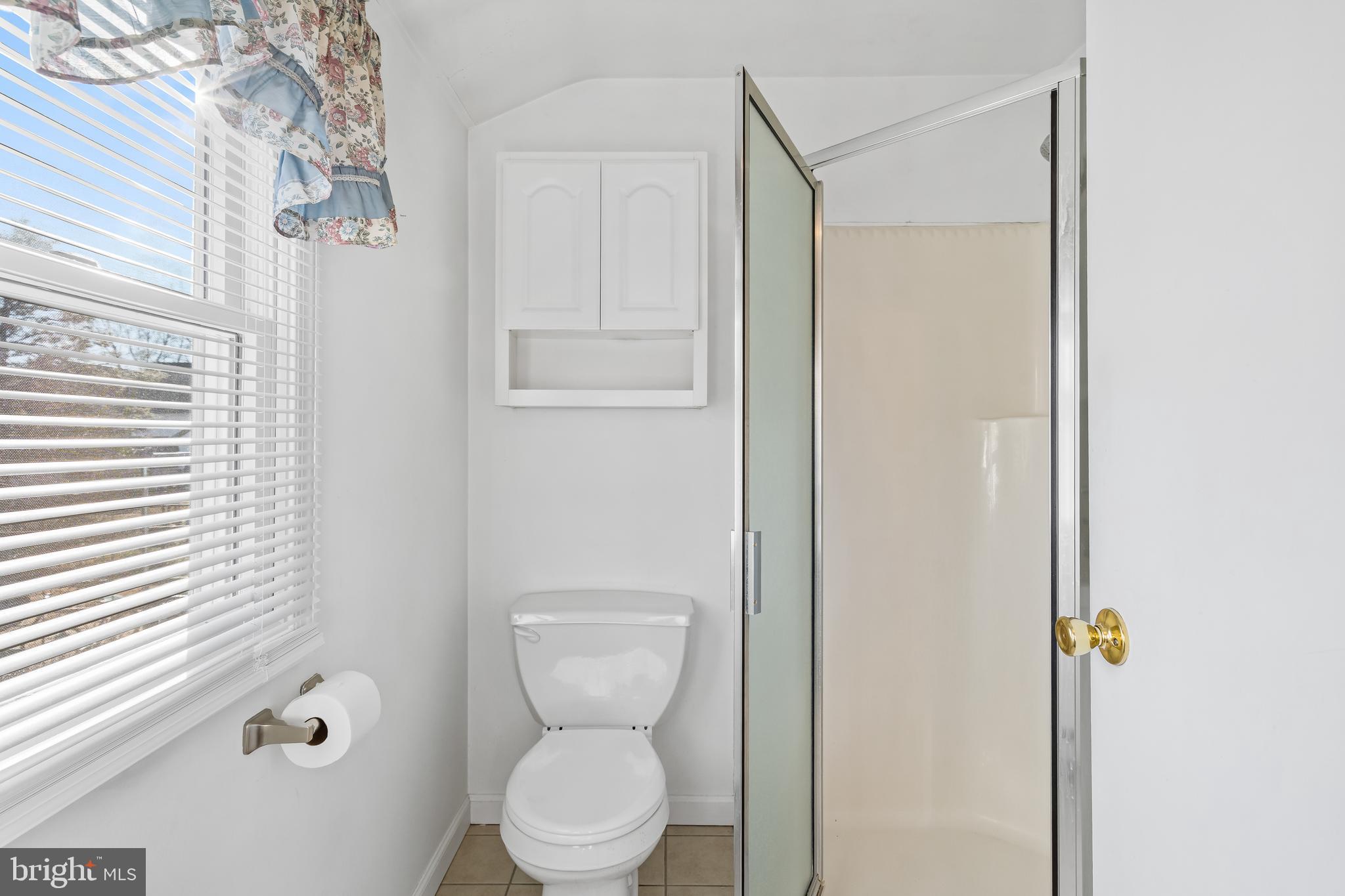 29 South 6th Street Quakertown, PA 18951 - Photo 23 of 51 a bathroom with a toilet a sink and a window