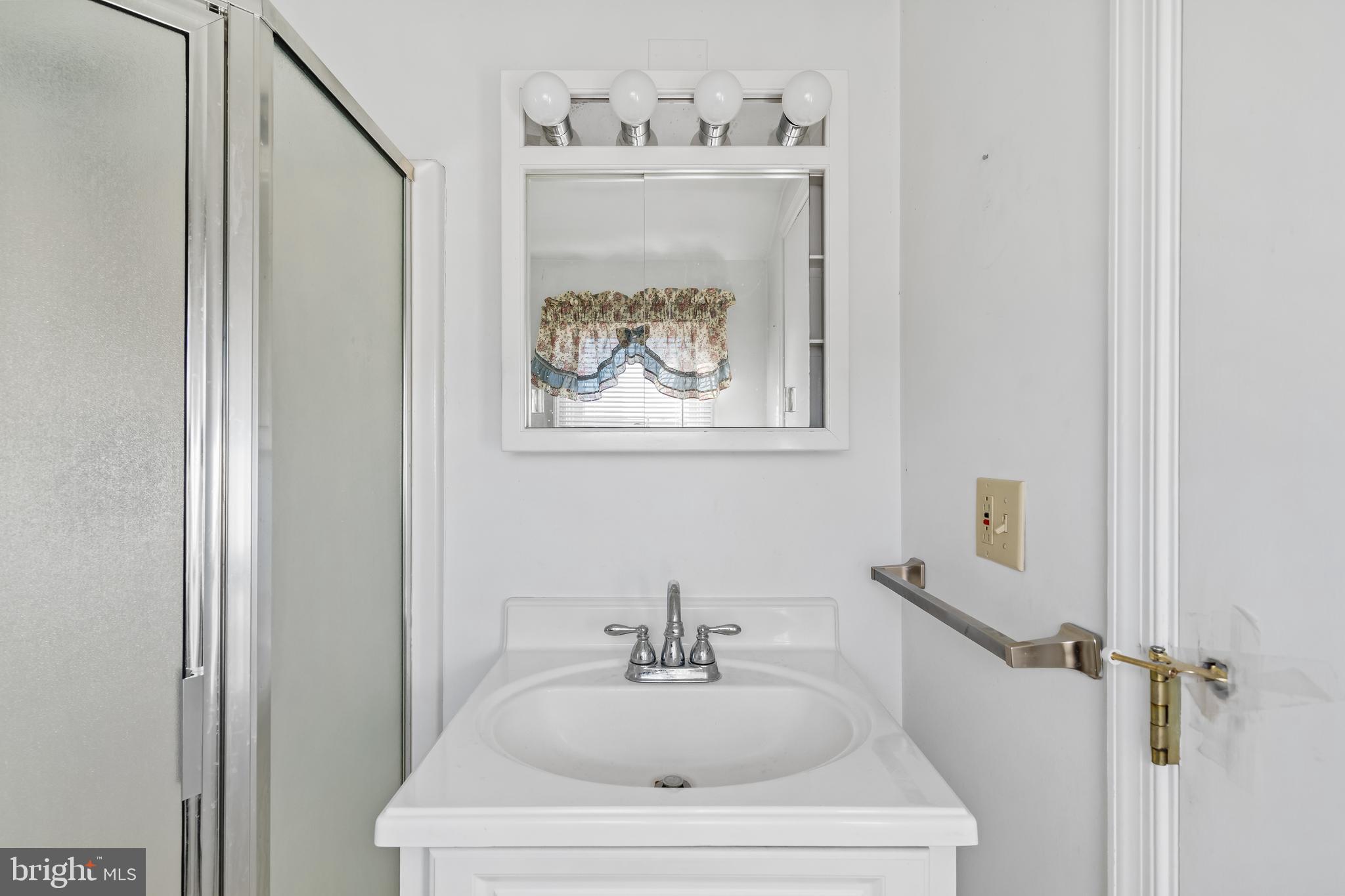 29 South 6th Street Quakertown, PA 18951 - Photo 24 of 51 a bathroom with a sink and a mirror