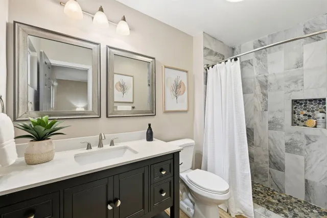 a bathroom with a sink toilet and shower