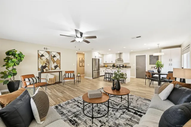 a living room with furniture and kitchen view