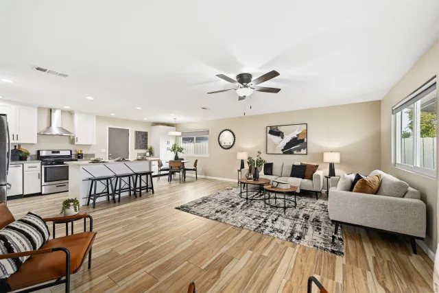 a living room with furniture and wooden floor