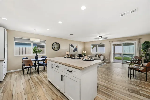 a view of a kitchen with dining area a sink and wooden floor