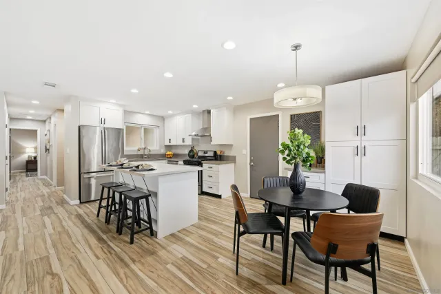 a view of a dining room with furniture and wooden floor
