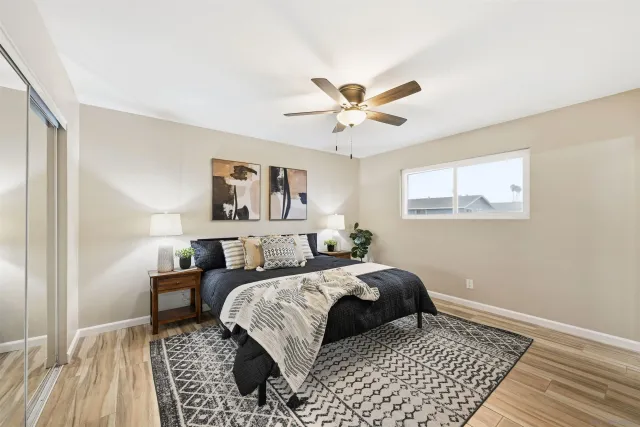 a bedroom with a bed lamp and a window