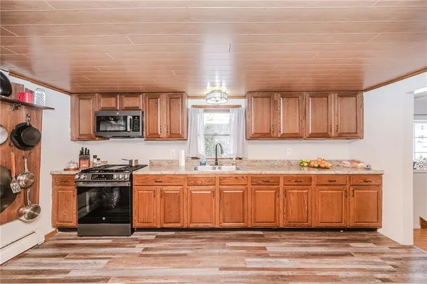 a kitchen with stainless steel appliances a stove a sink and a microwave