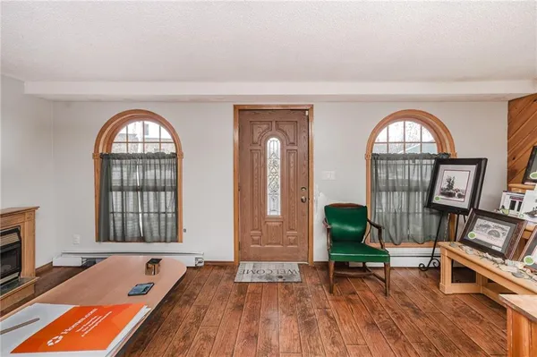 a view of a livingroom with furniture and a floor to ceiling window