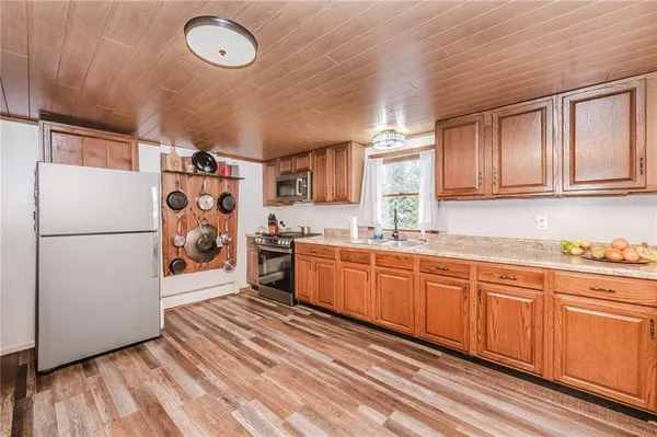 a kitchen with stainless steel appliances granite countertop a refrigerator sink and cabinets