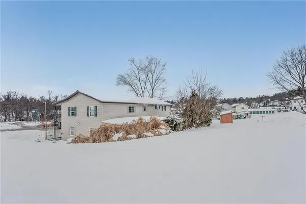 a view of a house with a snow in the yard