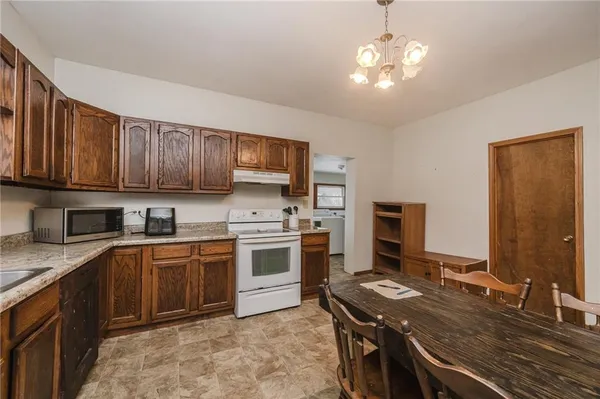 a kitchen with a sink stove and microwave