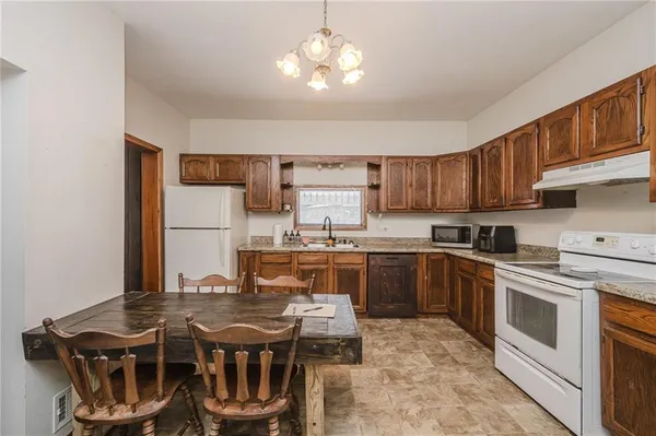 a kitchen with a stove a sink and a refrigerator