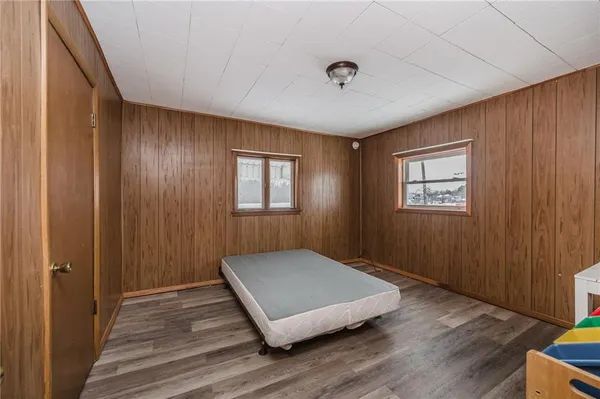 a view of a room with wooden floor and window