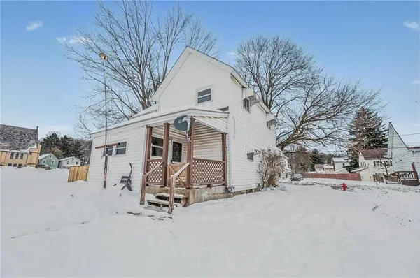 a view of a house with a snow in the yard