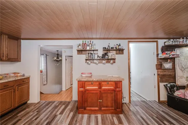 a kitchen with stainless steel appliances a refrigerator and wooden floor