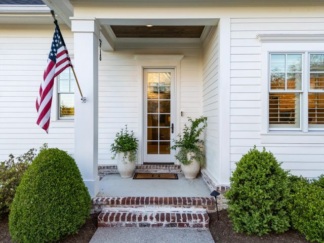 a view of a patio with couches table and chairs under an umbrella
