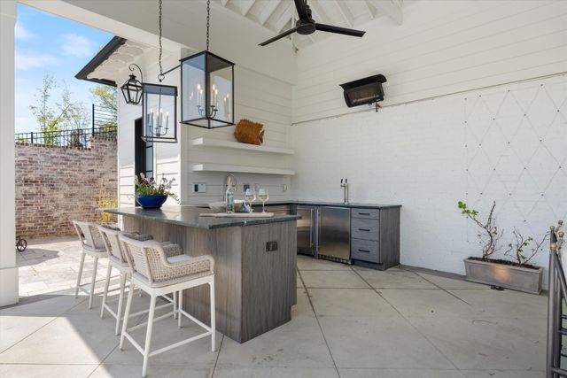 a living room with furniture a fireplace and a chandelier