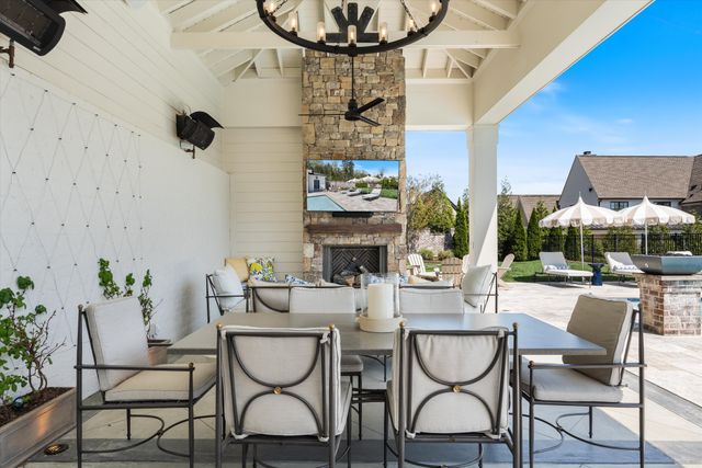 a living room with furniture a fireplace and a potted plant