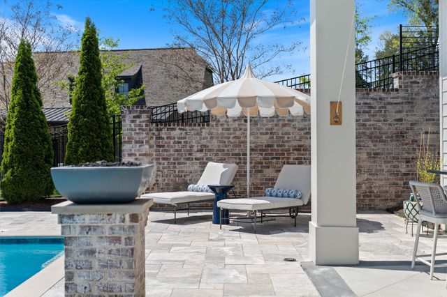 a dining room with furniture a chandelier and wooden floor