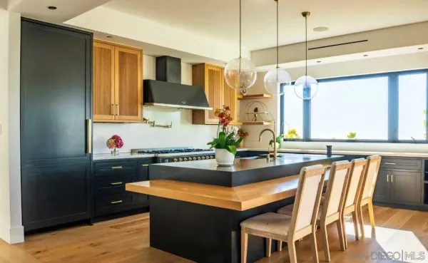 a kitchen with stainless steel appliances granite countertop a sink and a refrigerator