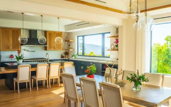 a room with stainless steel appliances kitchen island granite countertop furniture and a view of living room