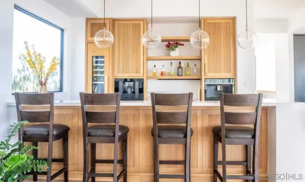 a kitchen with stainless steel appliances kitchen island granite countertop a table and chairs